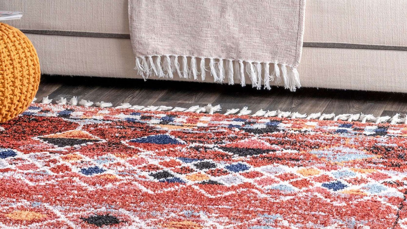 red rug in front of couch