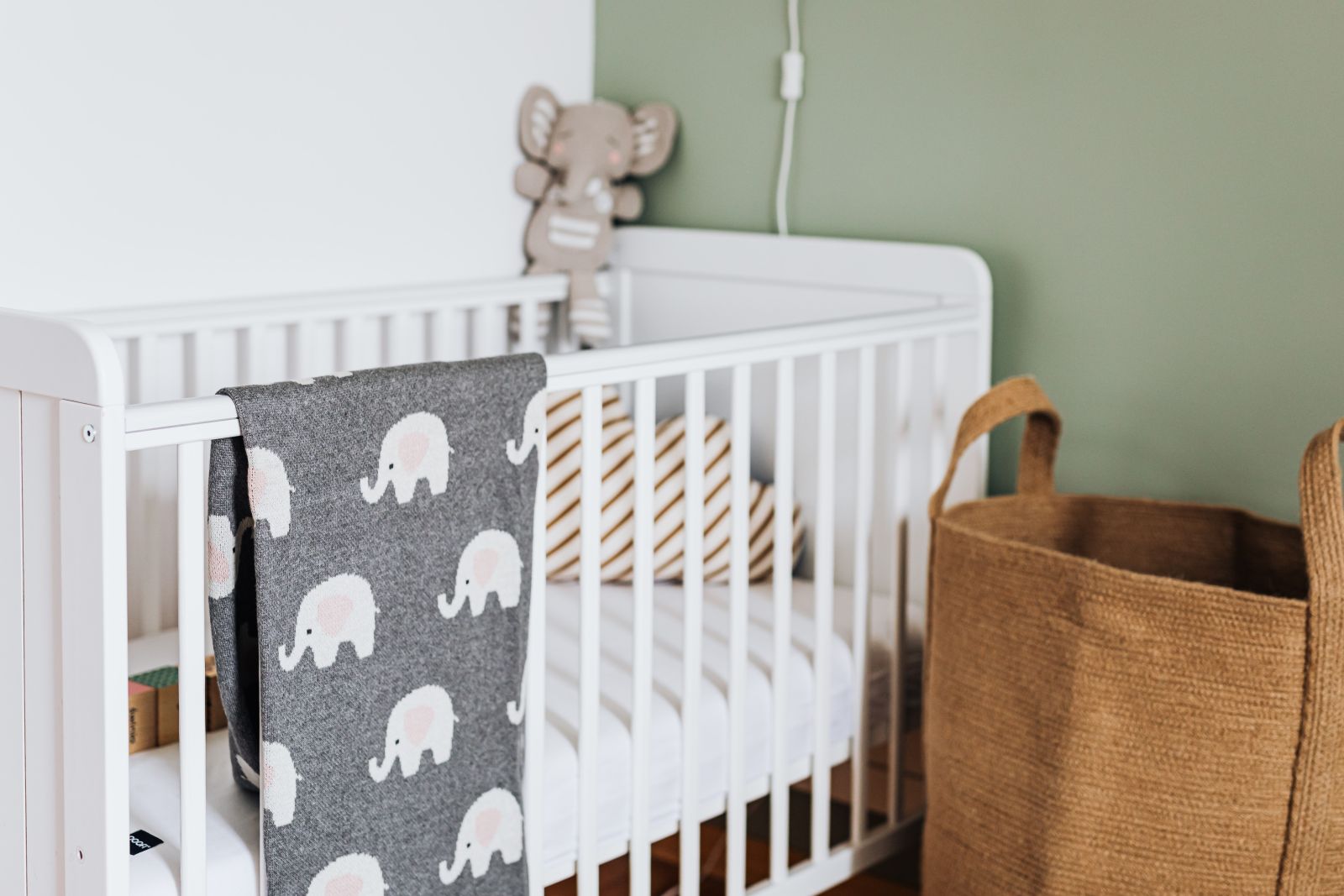 nursery crib with green walls