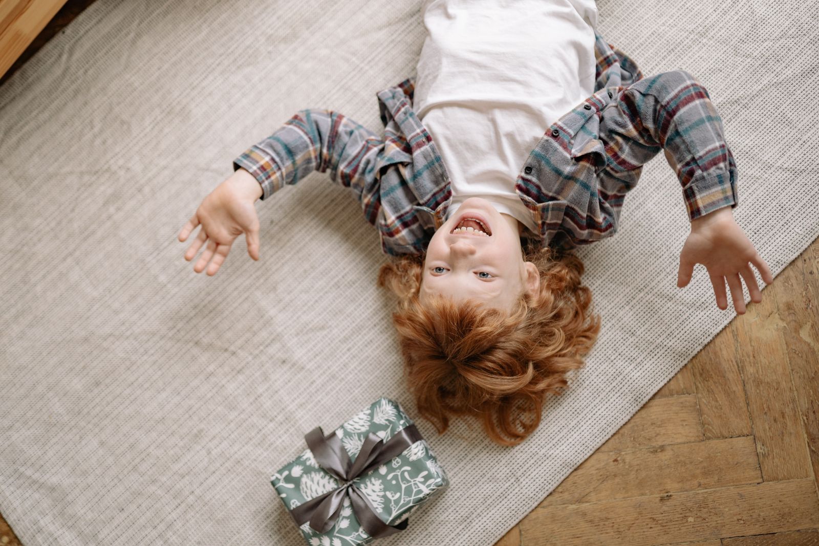 happy child lying on rug